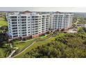 Luxury condo building with pool and lush landscaping at 2925 Terra Ceia Bay Blvd # 2203, Palmetto, FL 34221