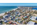 Aerial view showing a teal home close to the beach and other houses at 3704 6Th Ave # 5, Holmes Beach, FL 34217