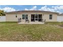 Home with screened patio, grassy yard, and paver patio at 4352 Adelaide Ave, North Port, FL 34288