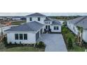 Two-story home with gray roof and paver driveway at 4517 Mondrian Ct, Sarasota, FL 34240