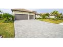 Large paver driveway leading to a three car garage at 4814 Sparkling Sea Ln, Lakewood Ranch, FL 34211