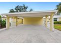 Carport with white columns and a concrete driveway at 5940 Driftwood Ave # 15, Sarasota, FL 34231