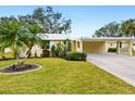 Charming yellow house with carport and landscaped yard at 5940 Driftwood Ave # 15, Sarasota, FL 34231