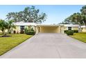 Front view of a yellow house with carport at 5940 Driftwood Ave # 15, Sarasota, FL 34231