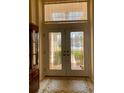 Interior entry with double doors and decorative rug at 636 Lakescene Drive Dr, Venice, FL 34293