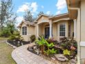 Front entry with blue door and a water feature at 8107 High Oaks Trl, Myakka City, FL 34251