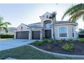 Two-story house with a two-car garage and lush landscaping at 1178 Fraser Pine Blvd, Sarasota, FL 34240