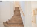 Elegant wooden staircase leading to the upper level at 1178 Fraser Pine Blvd, Sarasota, FL 34240