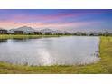 Community pond with houses and lush landscaping around it at 12810 Seasong Ter, Bradenton, FL 34211