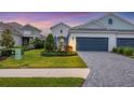 Two-story home with a three-car garage and landscaped front yard at 12810 Seasong Ter, Bradenton, FL 34211