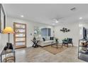 Bright living room with hardwood floors, comfy seating, and stylish decor at 1725 Solon Ave, Dunedin, FL 34698