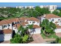 Luxury community home with tile roofs, white exteriors, and a waterfront view at 1906 Harbour Links Cir # 14, Longboat Key, FL 34228