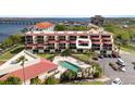 Aerial view of condo building showcasing a unit and pool at 204 3Rd W St # 203, Bradenton, FL 34205