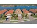 Community view showcasing a home near a lake at 204 Villoresi Blvd, Nokomis, FL 34275