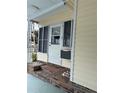 Side entrance with white door and brick steps at 2107 Palma Sola Blvd # 27, Bradenton, FL 34209
