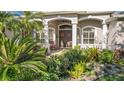 Front entry with lush landscaping and double doors at 2305 Little Country Rd, Parrish, FL 34219