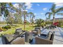 Outdoor patio area with fire pit and comfortable seating at 2305 Little Country Rd, Parrish, FL 34219