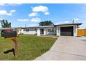 Newly renovated home with modern exterior and driveway at 240 Algiers Dr, Venice, FL 34293