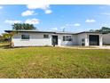 Newly renovated home with a modern exterior and lush lawn at 240 Algiers Dr, Venice, FL 34293