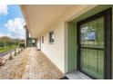 Exterior view of building showcasing entrance and landscaping at 3500 Beneva Rd # 303, Sarasota, FL 34232