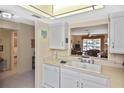 Condo kitchen features white cabinets and a pass-through to the living area at 365 Three Lakes Ln # G, Venice, FL 34285