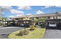 Condo complex with carport parking and lush landscaping at 365 Three Lakes Ln # G, Venice, FL 34285