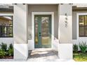 Modern front entry with a green door and paver walkway at 4497 N Salford Blvd, North Port, FL 34286
