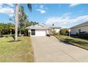 Front view of house, driveway, and palm tree at 4534 Fern Dr, Bradenton, FL 34208