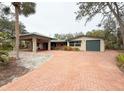 Brick paver driveway leads to a ranch style home with carport at 5353 Shadow Lawn Dr, Sarasota, FL 34242