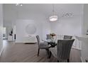 Bright dining area with glass table and grey chairs at 5469 Fair Oaks Street St # 5C, Bradenton, FL 34203