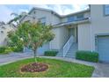 Front entrance of condo with stairs and lush landscaping at 5469 Fair Oaks Street St # 5C, Bradenton, FL 34203