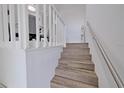 Modern staircase with wood-look flooring and metal railing at 5469 Fair Oaks Street St # 5C, Bradenton, FL 34203