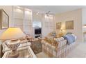 Bright living room featuring built-in shelving and a cozy atmosphere at 7561 Pesaro Dr, Sarasota, FL 34238