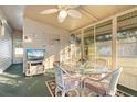 Bright sunroom with wicker furniture and glass-top table at 808 53Rd E Ave # L 226, Bradenton, FL 34203