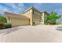 Two-car garage with paver driveway and beautiful landscaping at 9711 Sea Turtle Ter # 102, Bradenton, FL 34212