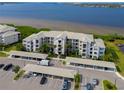 Aerial view of waterfront condo building with covered parking at 1030 Tidewater Shores Loop # 306, Bradenton, FL 34208