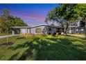 Newly renovated single-story home featuring a modern facade and well-maintained lawn at 104 24Th Ne St, Bradenton, FL 34208