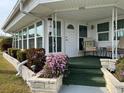 Covered porch with seating area and landscaping at 1111 42Nd E Ave, Ellenton, FL 34222