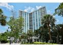 Towering condo building with balconies and lush landscaping at 1111 N Gulfstream Ave # 4E, Sarasota, FL 34236