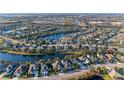 Aerial view showcasing a home's location in a desirable neighborhood near a lake at 12031 Longview Lake Cir, Bradenton, FL 34211