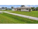 Single story house with a green lawn and sidewalk at 1215 E Venice Ave, Venice, FL 34285