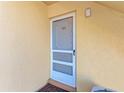 White front door with screen door and number 101 at 129 Tyler Dr # 101, Sarasota, FL 34236