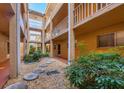 Ground level courtyard with walking path and plants at 1330 Glen Oaks E Dr # 268D, Sarasota, FL 34232