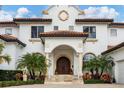 Mediterranean-style home with detailed stone facade and arched entryway at 1389 Tangier Way, Sarasota, FL 34239