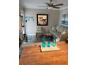 Living room with light walls, comfy seating, and a view of the kitchen at 1603 Gulf N Dr # 27, Bradenton Beach, FL 34217