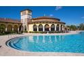 Resort-style pool with a clubhouse in the background at 20165 Tesoro Dr, Venice, FL 34293