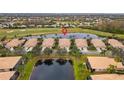 Community overview featuring houses, lake, and golf course at 288 Fairway Isles Ln, Bradenton, FL 34212