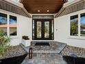 Elegant entryway with modern double doors and a stone walkway at 3178 Dick Wilson Dr, Sarasota, FL 34240
