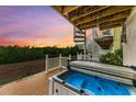 Relaxing hot tub on deck with spiral staircase and sunset view at 3524 Walker Is, Bradenton, FL 34208