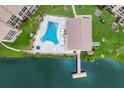 An aerial view of a condo community pool, deck, and dock at 3544 Lake Bayshore Dr # K123, Bradenton, FL 34205